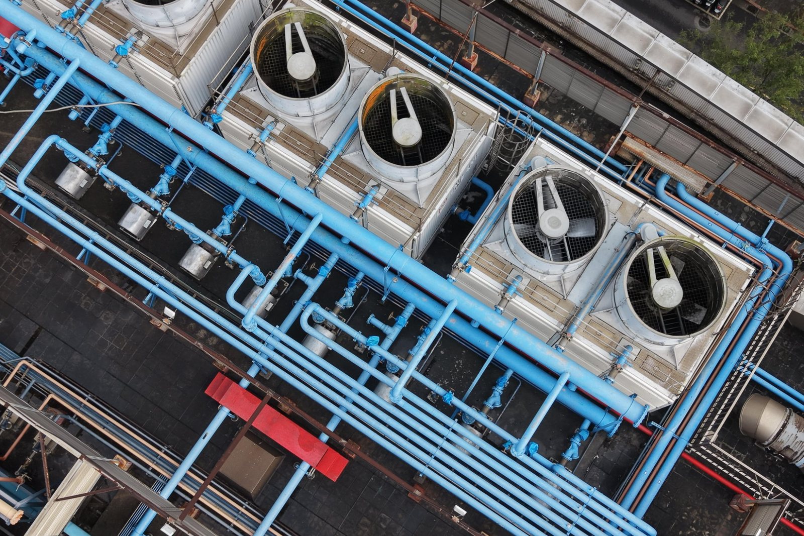 Aerial view of packaged cooling tower cells and the pipework feeding them